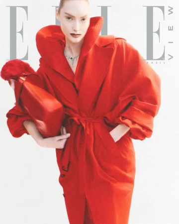 Fashion editorial featuring a woman in a red coat holding a red purse, posing against a white background, for an Elle magazine cover.