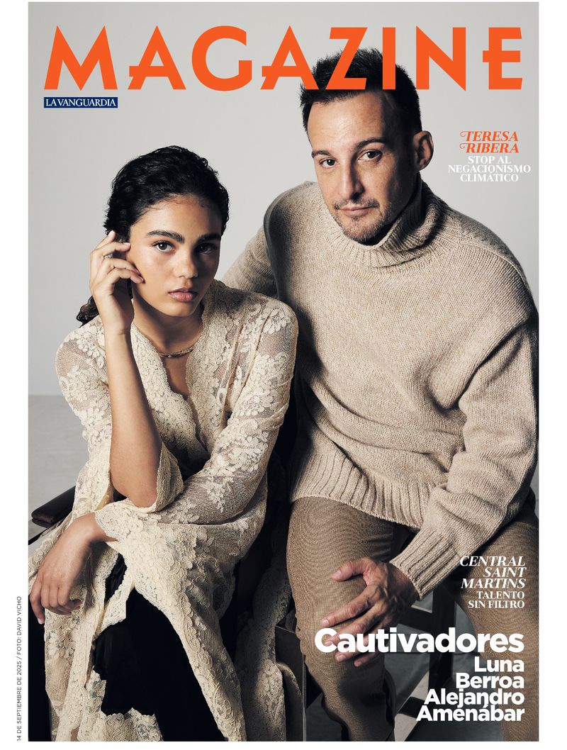 Magazine cover featuring a young adult woman in a lace robe and an adult man in a sweater posing indoors against a neutral backdrop.