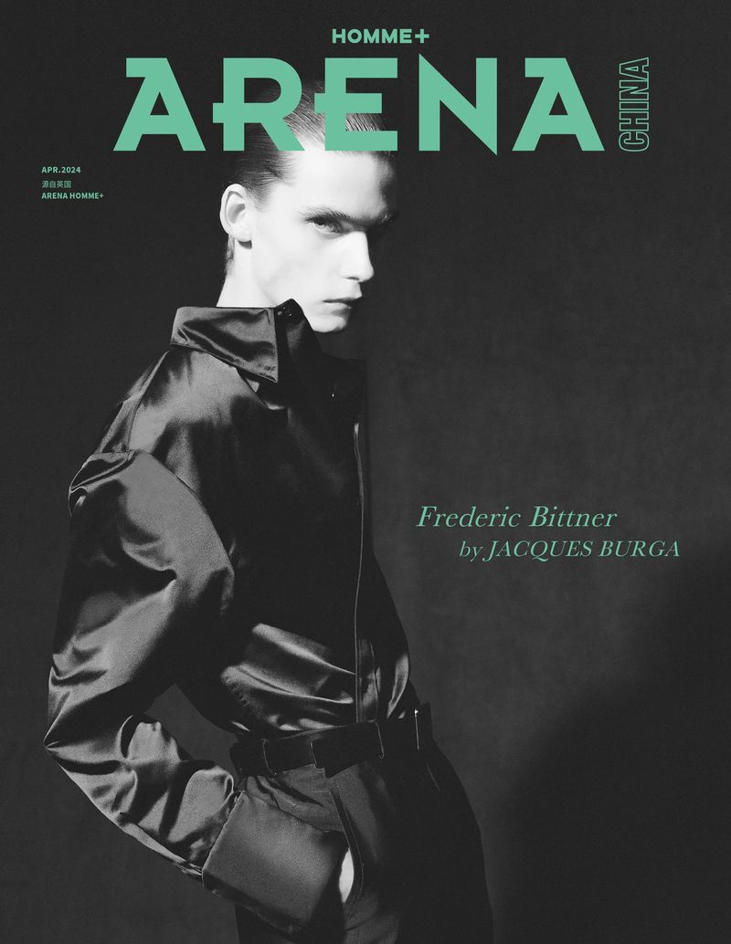 Arena Homme+ magazine cover features Frederic Bittner in a satin jumpsuit against a dark background. Minimalist lighting, editorial style.
