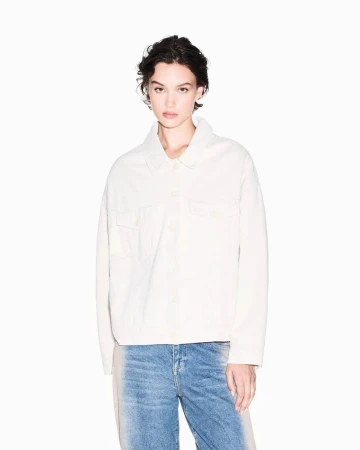 Model wearing an off-white buttoned jacket and faded blue jeans against a white seamless background for Armani Exchange F/W 2025.