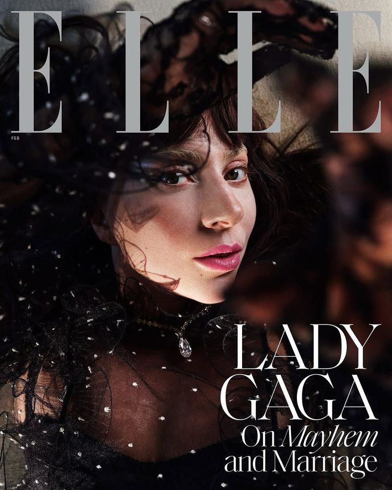 Elle magazine cover featuring Lady Gaga with dark hair, lace detail and pink lips. The image is a close-up shot with a soft, diffused light.