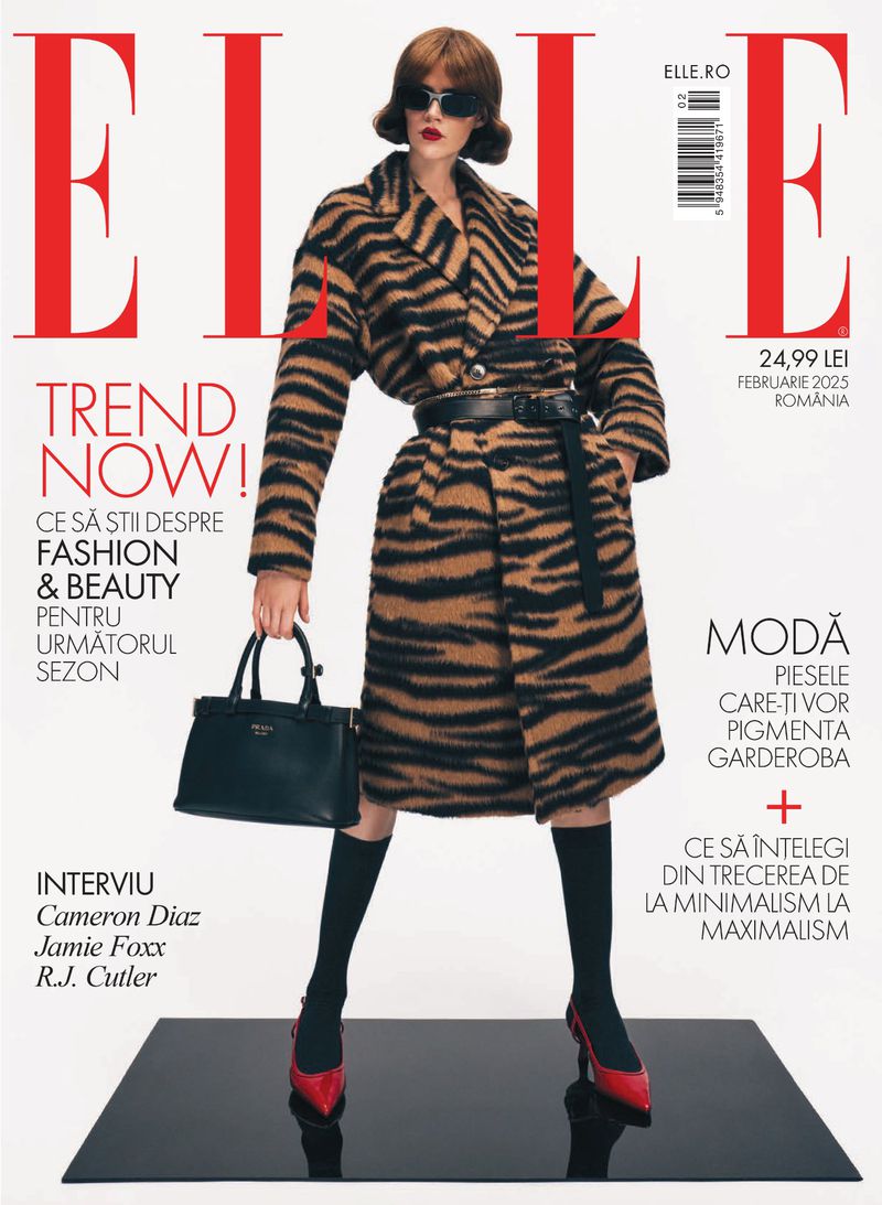 Elle Romania magazine cover features a woman in a zebra-striped coat, sunglasses, and red heels, holding a black handbag against a black surface.