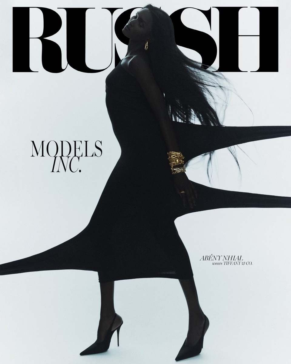 A striking fashion shot features a dark-skinned model in a flowing black dress and heels, accessorized with gold jewelry, against a clean white backdrop.