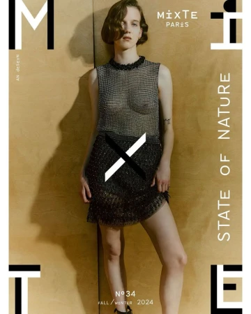 Fashion editorial magazine cover featuring a female model wearing a sparkly gray two-piece outfit on a wooden background.