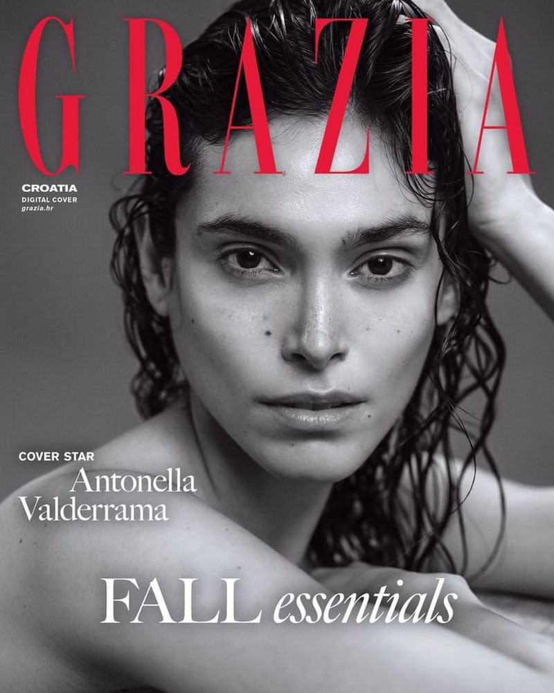Close-up of a young adult woman with dark hair posing for a fashion magazine cover, featuring red text and fall fashion themes on a grey backdrop.
