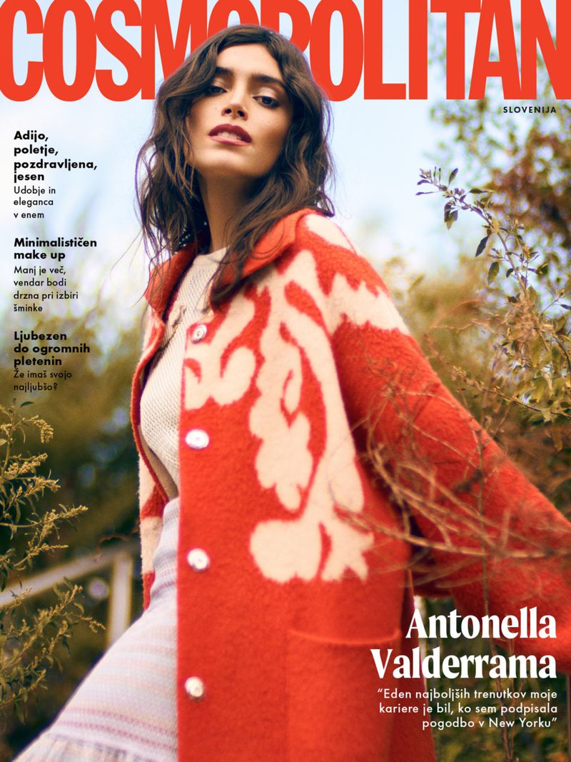Cosmopolitan Slovenia cover featuring Antonella Valderrama in a patterned orange coat, posing outdoors against a natural backdrop.