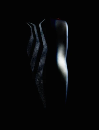 Sleek, dark athletic shirt with subtle texture and reflective design elements, set against a deep black background in a studio setting.