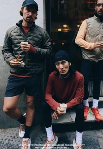 Three male runners in performance sportswear holding coffee cups outside on a city street for Zara Man Speed Run.