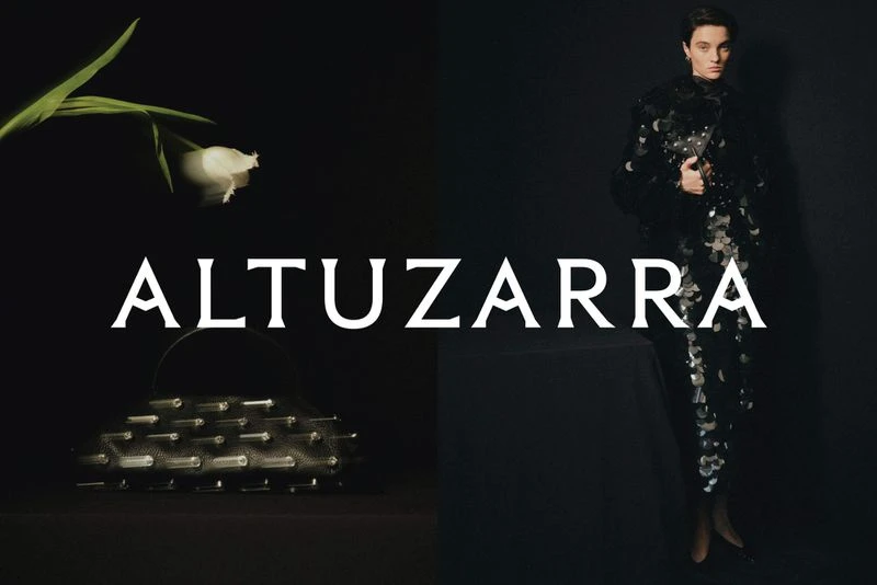 Fashion shot featuring a woman in an embellished black dress, complemented by a white flower and an evening bag on a dark background.