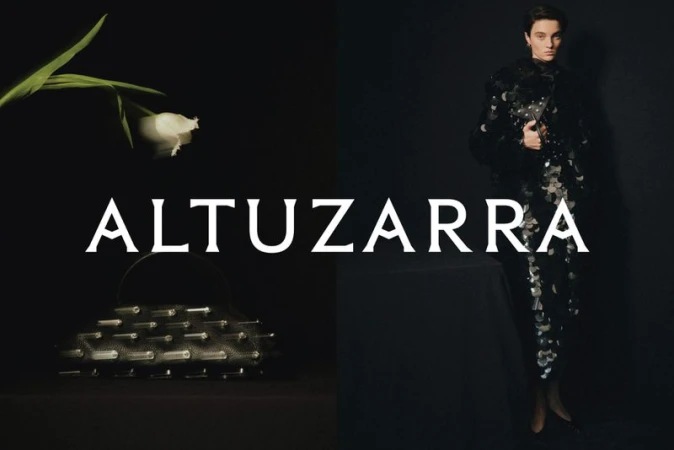 Fashion shot featuring a woman in an embellished black dress, complemented by a white flower and an evening bag on a dark background.