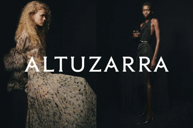 Two fashion models showcase Altuzarra designs against a dark background. The left model wears a long printed dress, while the right model is in a black dress.