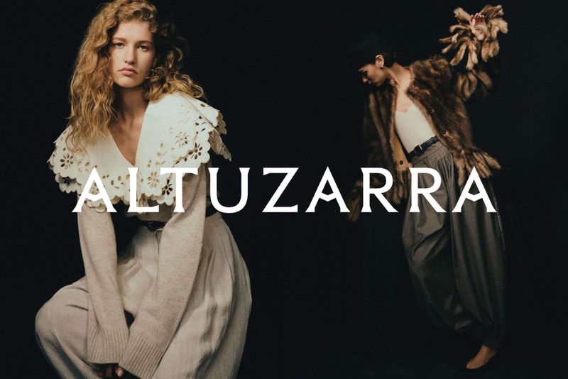 Fashion editorial featuring two models in stylish clothing against a dark backdrop, with a large text overlay of the brand name.