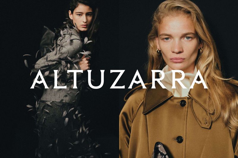 Two models showcasing Altuzarra fashion designs against a dark black studio background with overlaid white brand typography