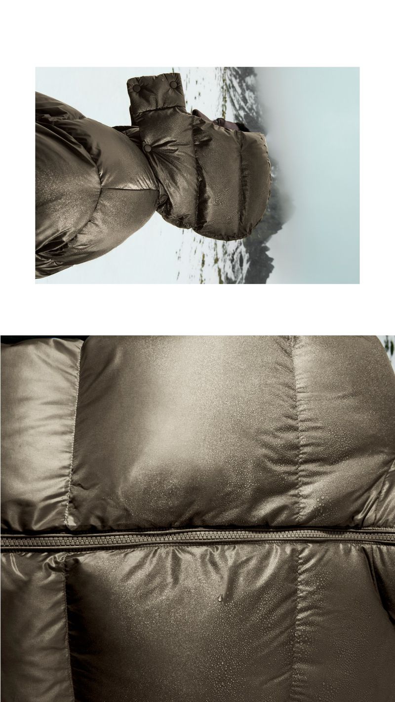 Close-up of brown puffer jacket with visible stitching, set against a blurred mountain landscape with snow and mist.