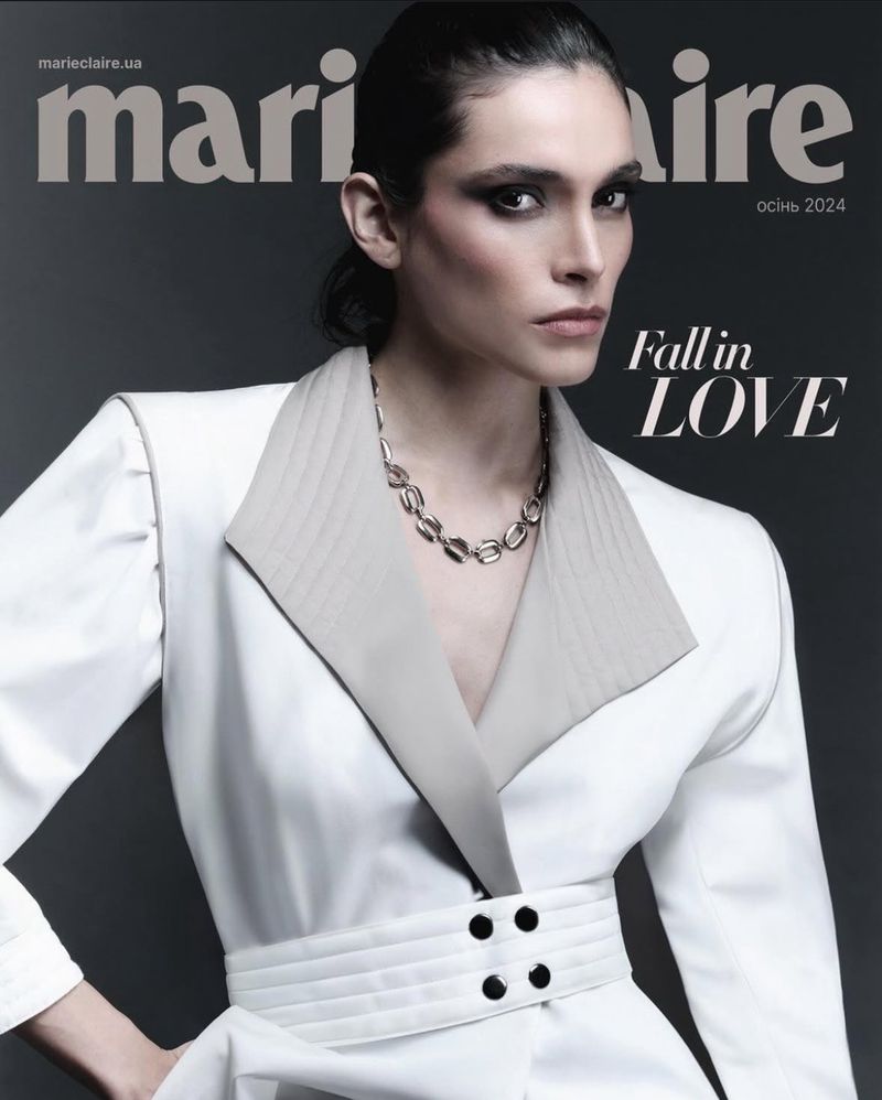 Marie Claire Ukraine magazine cover featuring a model in a white coat, wearing a silver necklace, photographed in a studio setting.