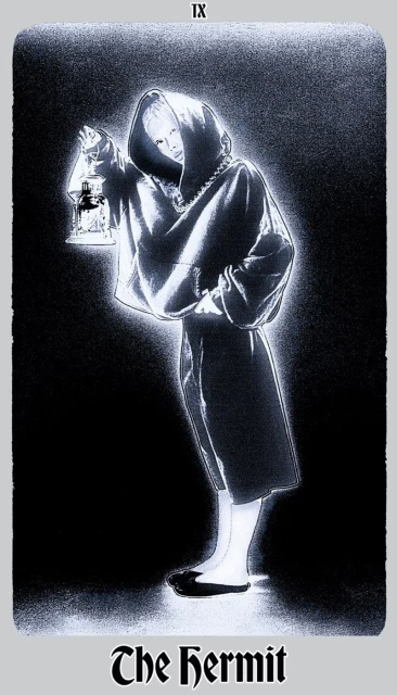 Monochromatic image of a person cloaked in shadow, holding a lantern, reminiscent of a tarot card illustration with 'The Hermit' text.