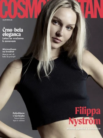 Blonde woman wearing a black ribbed tank top against a dark grey seamless studio backdrop for a magazine cover.