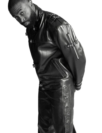 A stylish adult male in a sleek black leather jacket and matching pants, looking intently at the camera against a crisp white backdrop.