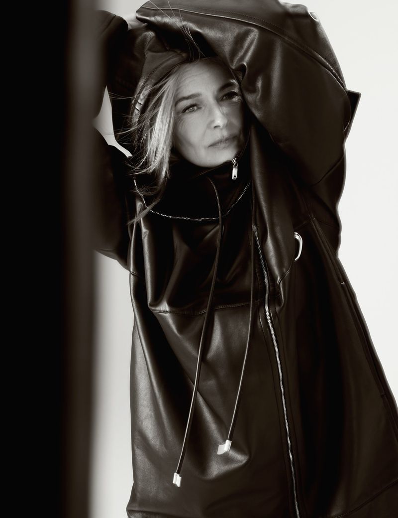 Portrait of woman wearing a black leather jacket with a neutral expression. Neutral background, studio lighting and monochrome color.