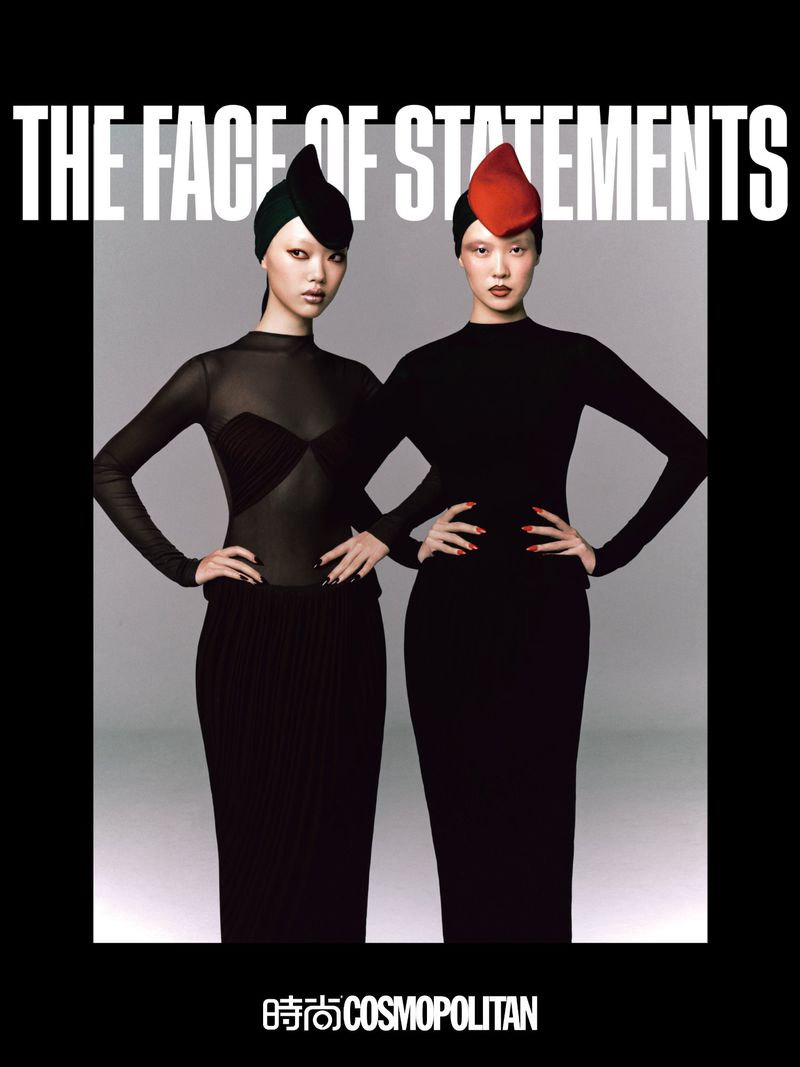 Editorial fashion shot of two Asian women in fitted black dresses and avant-garde hats posing in front of a soft grey backdrop.