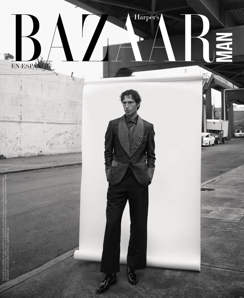 Black and white Harper's Bazaar Man cover featuring a man in a suit, standing against a white backdrop in an urban setting.