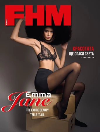 FHM magazine cover featuring a model in lingerie and stockings, seated on stacked boxes with a dramatic, dark background.