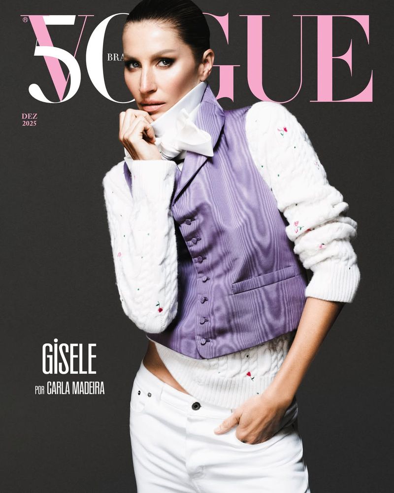 Vogue Brasil cover featuring Gisele Bündchen in a white top and lavender vest, posing against a gray background with pink Vogue lettering.