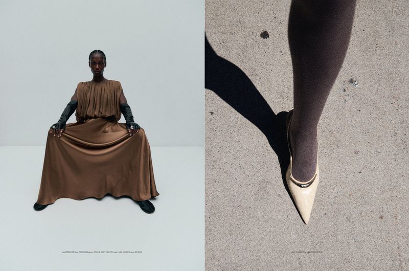 Fashion shot of a slender Black woman in a brown dress, full gloves, and rings, with a heel on concrete background.