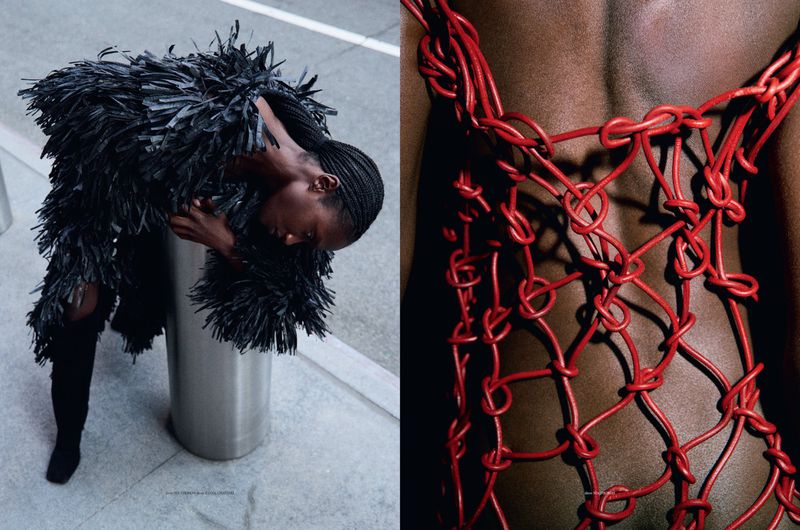 Fashion shot featuring an African-American woman in a black textured coat leaning against a silver column, contrasted with a red string garment detail.