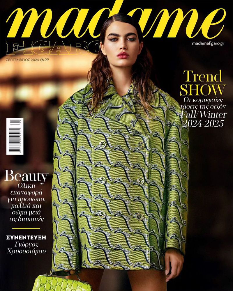 Fashion magazine cover featuring a female model in a green patterned coat and lime green purse against a blurred background.