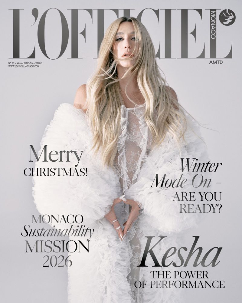 L'Officiel Monaco magazine cover featuring Kesha in a white lacy dress and voluminous sleeves against a light background with magazine text.