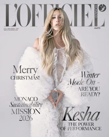 L'Officiel Monaco magazine cover featuring Kesha in a white lacy dress and voluminous sleeves against a light background with magazine text.