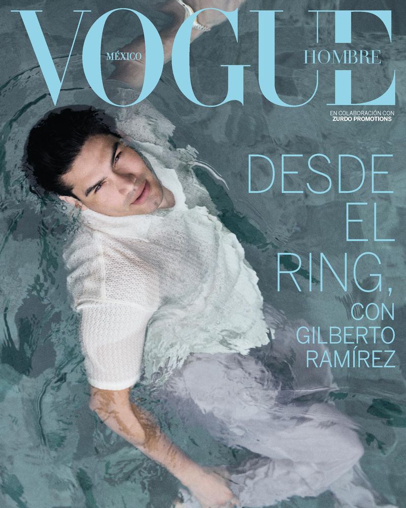 Vogue Mexico cover featuring a man in a white shirt and pants partially submerged in water, posing for a striking fashion image.