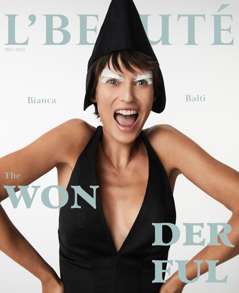 Magazine cover featuring Bianca Balti with artistic white eyebrow makeup, wearing a black top and hat, with 'L'BEAUTE' text.