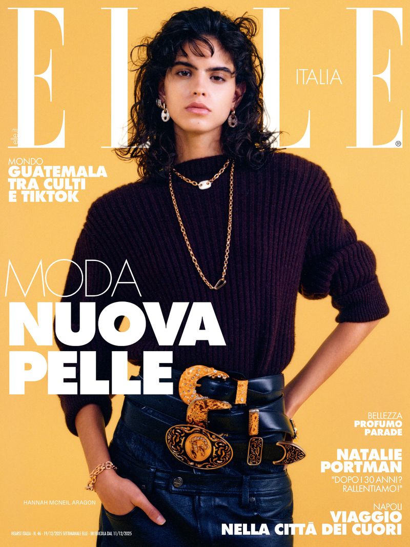 Elle Italia magazine cover featuring a woman with curly dark hair, wearing a dark sweater, leather pants, and multiple belts with gold buckles.