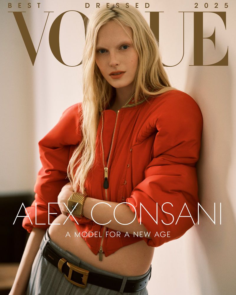Vogue magazine cover featuring a blonde woman in a red puffer jacket and grey pants, accessorized with a gold bracelet and belt.