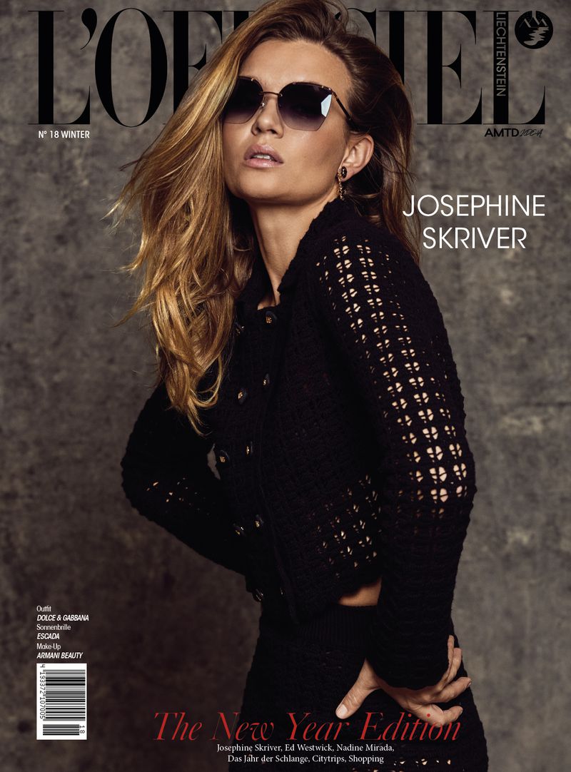 Josephine Skriver graces the cover of L'Officiel Liechtenstein Winter Issue, wearing sunglasses and a black knit jacket against gray backdrop.