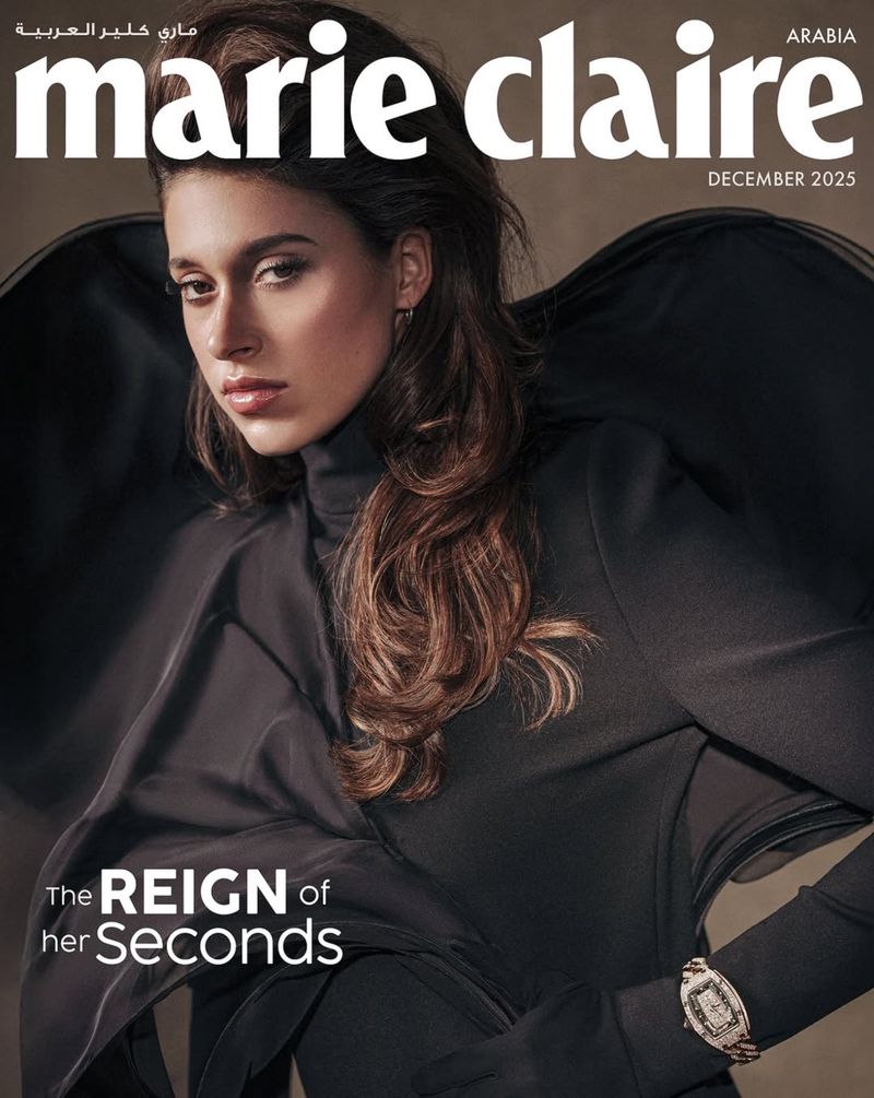 Fashion editorial shot of a woman in a green dress posing in a field against a cloudy sky for Marie Claire Arabia 2025 cover.