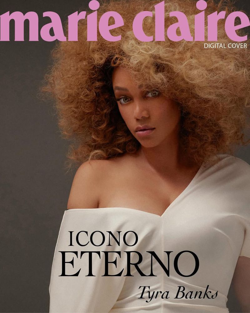 Marie Claire magazine cover featuring Tyra Banks in a white dress against a grey background, with large, styled blonde curly hair.