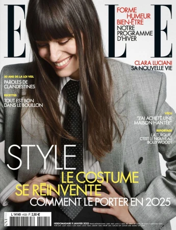 Elle magazine cover featuring a woman with long hair, wearing a blazer and tie, smiling, with magazine text overlay.