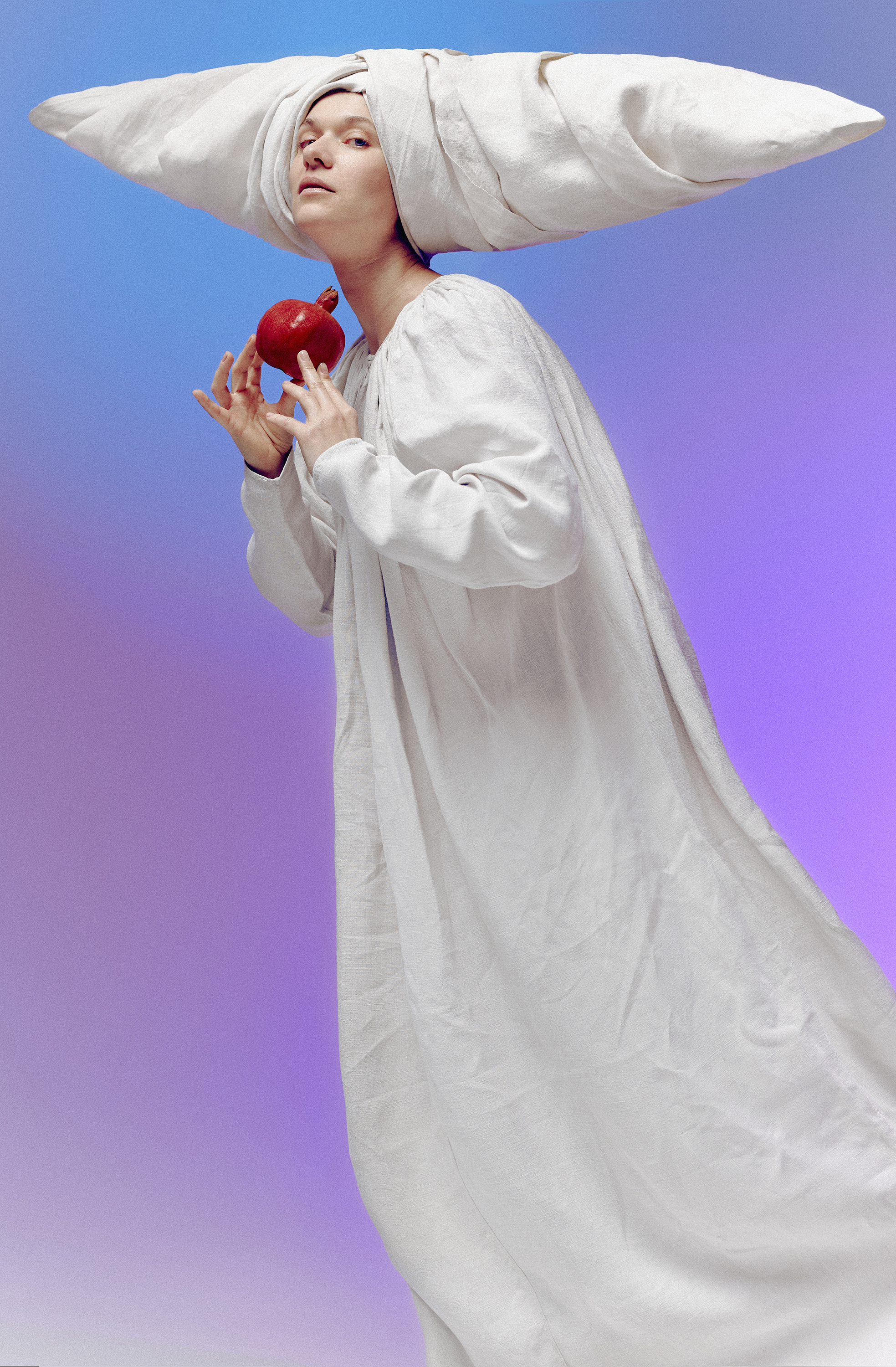 A portrait-style photograph features an adult female with dark hair, set against a dark studio backdrop with creative lighting emphasizing her facial features.
