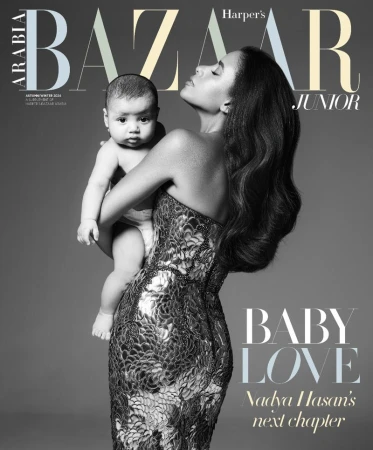 Harper's Bazaar Junior cover featuring an adult female holding a baby. The woman is wearing a strapless dress and posing in a studio.