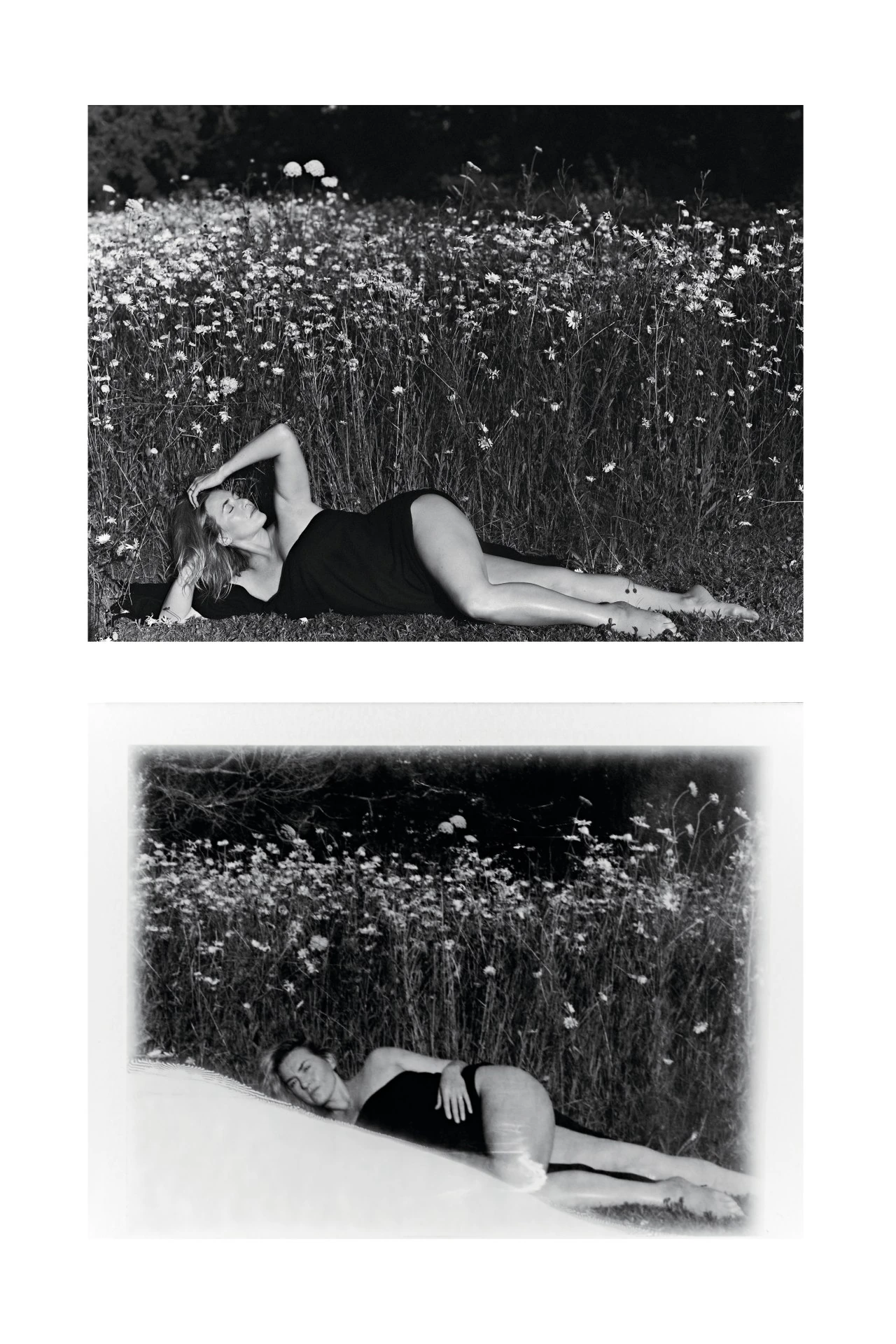 Monochrome outdoor portrait of a reclining adult woman in a black garment amidst a field of daisies with dark woods in the background.