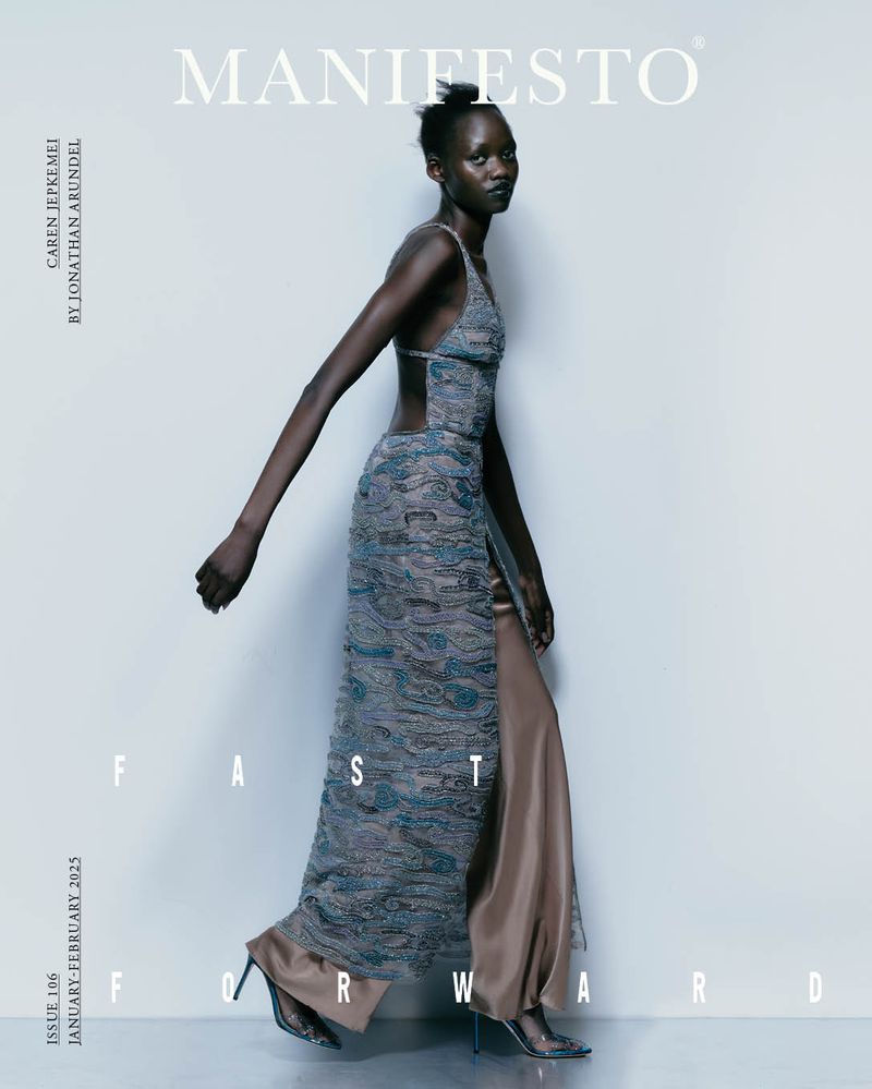 Fashion editorial shot of a slender Black model in a long dress, posing against a grey background for 'Manifesto' magazine cover.