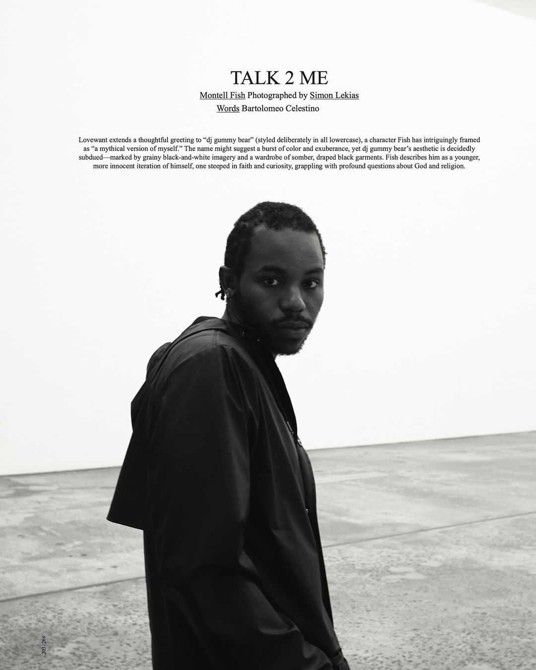 Black and white portrait of a black man wearing a dark jacket in a minimal gallery interior for Love Want.