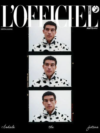 Cover layout featuring three vertical film frames of a male model wearing a cow print fleece jacket against a white background