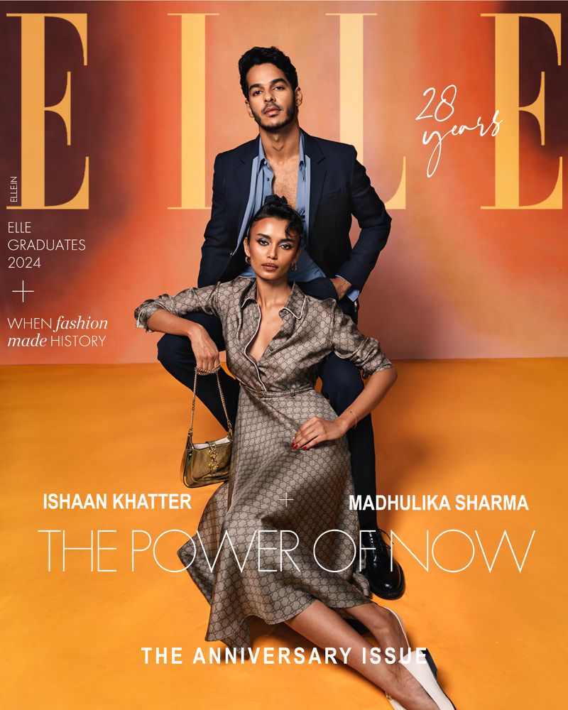 Magazine cover featuring a stylish couple: a woman in a patterned dress seated, and a man in a suit standing behind her, against a gradient background.