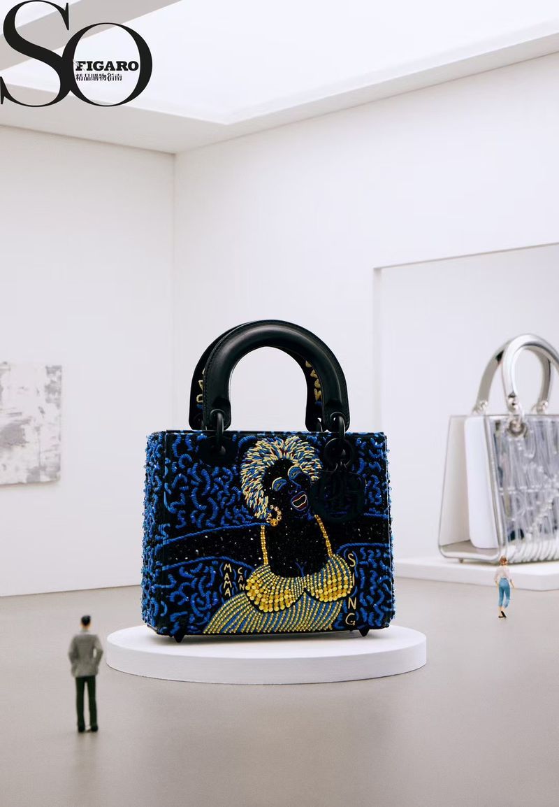 Fashion handbag with an image of a female performer, on a pedestal in a gallery, observed by miniature people.  