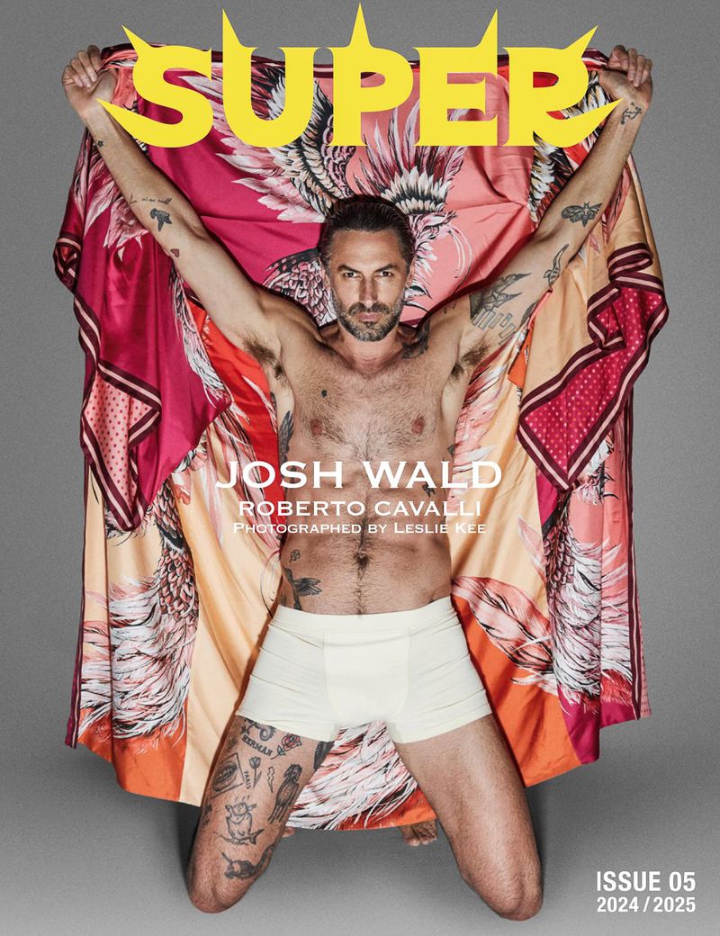 Josh Wald poses shirtless on the cover of SUPER magazine wearing underwear, holding a colourful garment with a print design.