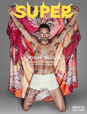 Josh Wald poses shirtless on the cover of SUPER magazine wearing underwear, holding a colourful garment with a print design.